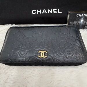 CHANEL Black lambskin, Camelia Embossed Leather zipper wallet